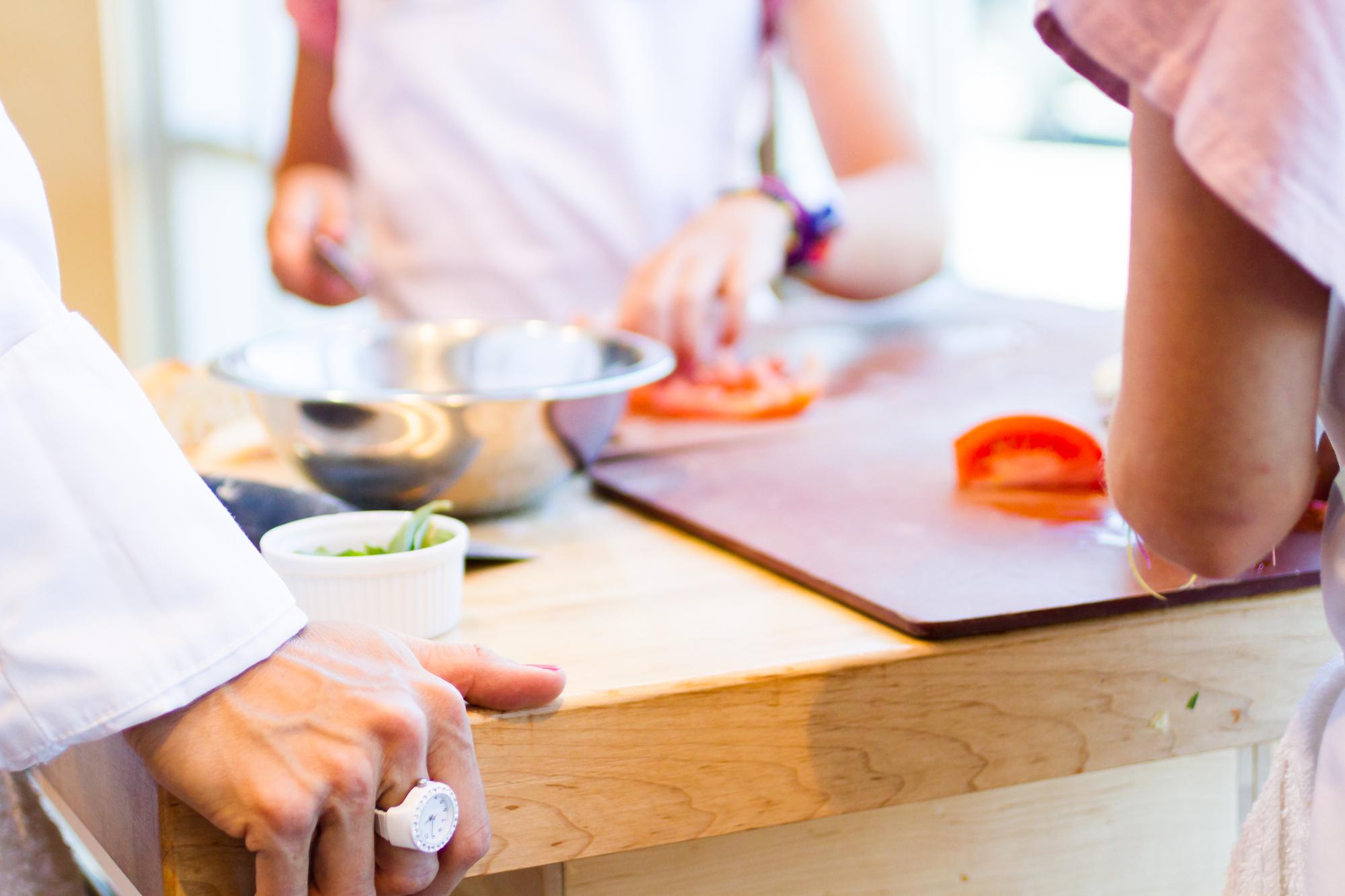 Instructor guiding a small cooking class